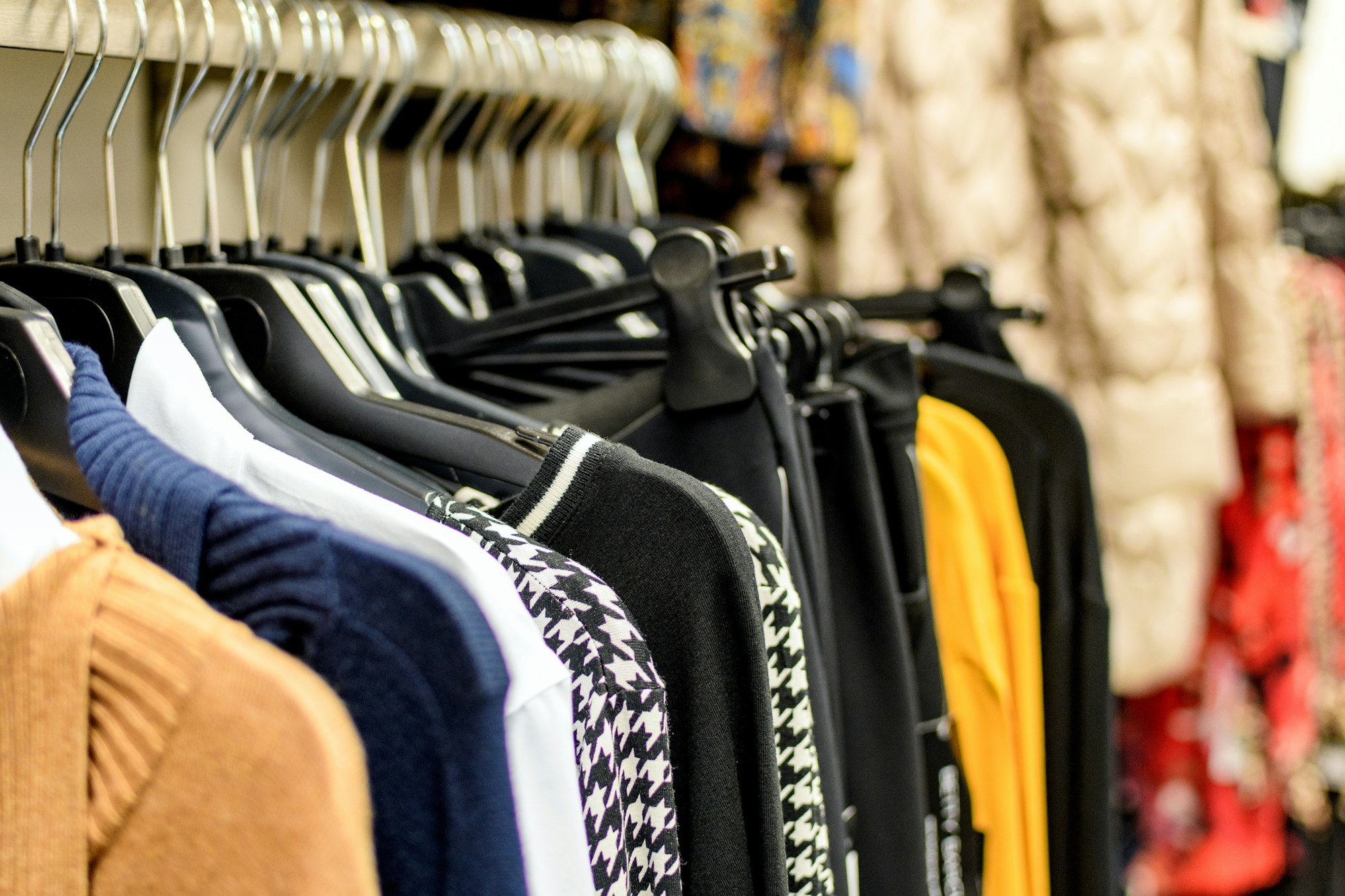 Clothes on hangers in an apparel retail store.