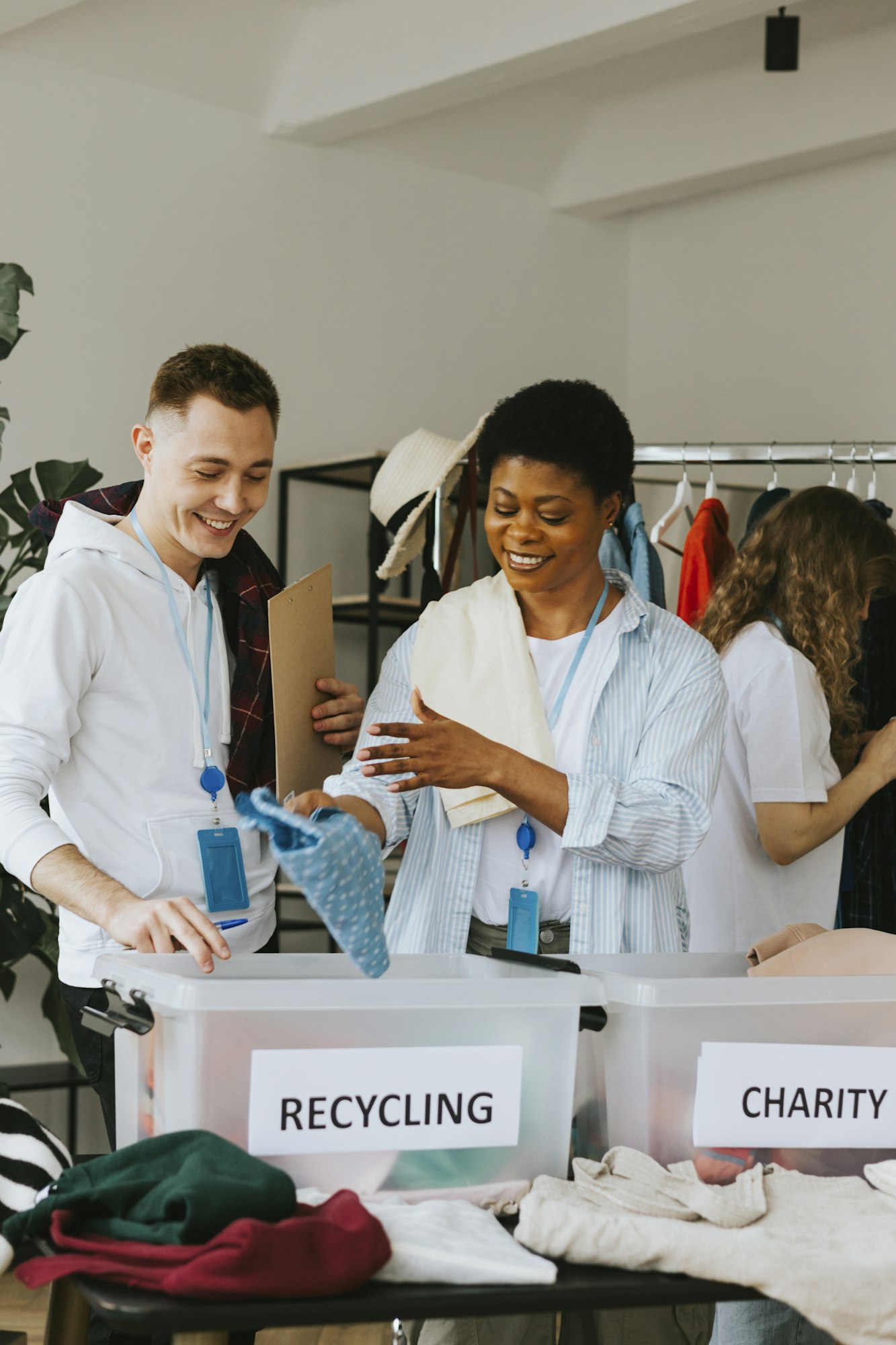 young people are engaged in charity and volunteering, selecting clothes for recycling and charity